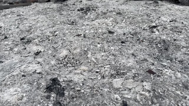 Wide shot of gray and white volcanic ash texture ground surface
