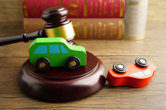 Car accident lawsuit and insurance, Judge hammer with car model.