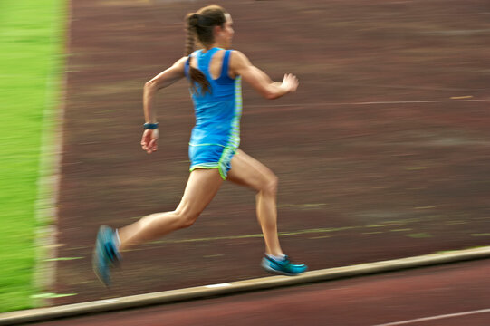 Woman running on tartan track