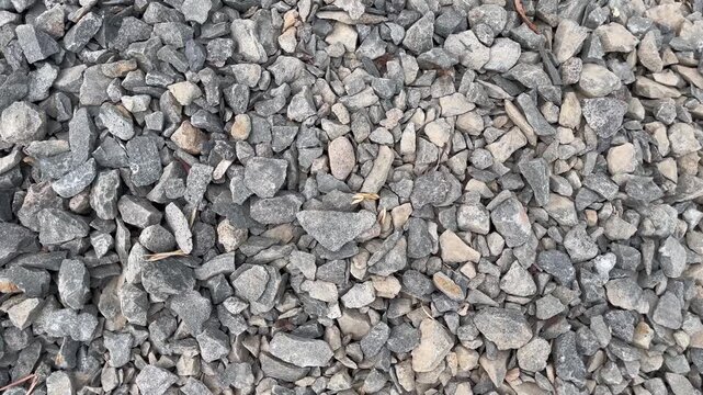 High angle view of grey crushed gravel stone texture background