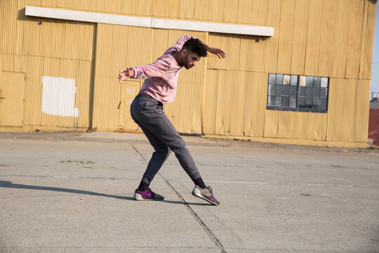 Stylish young man dancing outdoors
