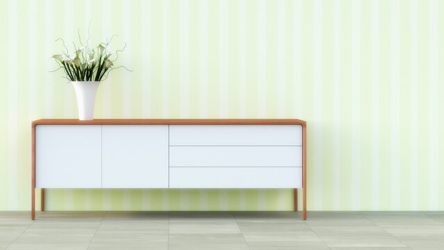 Sideboard with flower vase in front of striped wallpaper