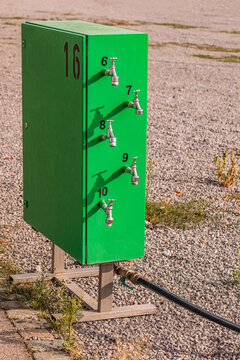 Green mobile water distributor stands on public ground in Germany