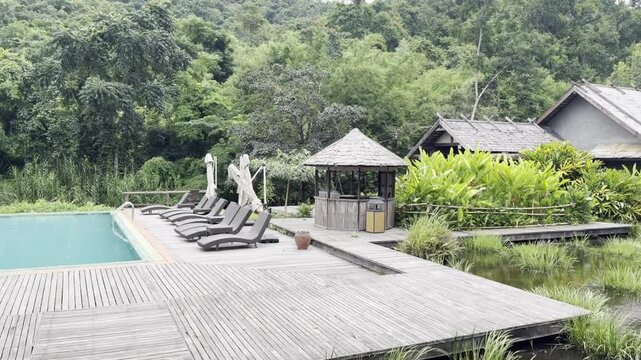 Beautiful Asian Style Garden Pond with Swimming Koi Fishes, Nam Kat Yorla Pa Resort in Laos