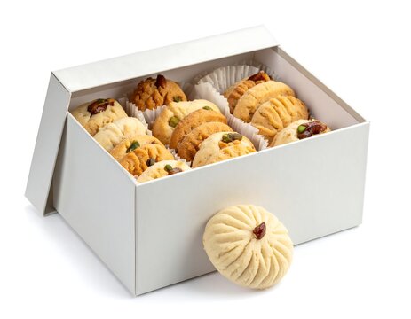  gift box of butter swirl cookies topped with chocolate and nuts isolated on white background
