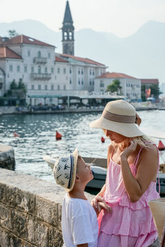 Mother and son looking at each other by waterfront