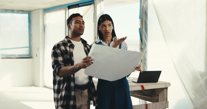 Couple, reading and blueprint at new house for renovation, interior design and unfinished property. People, talking and construction at site with document, floor plan and makeover of home improvement