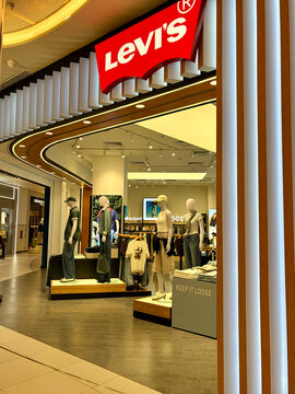 A Levi's store featuring well-displayed mannequins dressed in casual clothing. The store has modern lighting and sleek design elements. The sign displays the Levi's logo prominently.