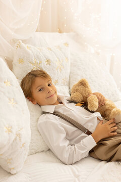 Happy child on Christmas, enjoying some quality time, opening presents, kids on Christmas eve in decorated home