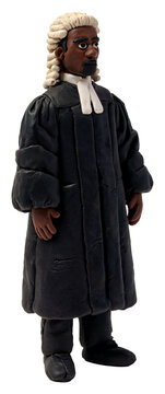 Clay figure of a Black judge in traditional robes and wig