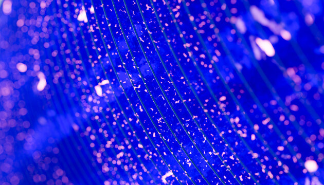 Close-up abstract pattern of glowing blue and pink dots with curved