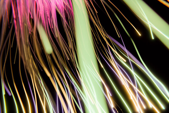 Colorful abstract light streaks with flowing motion on Black