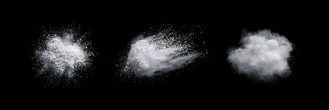 Set of white snow powder explosions on a black background. Dynamic dust clouds and flying flour particles. Abstract motion overlay.