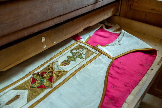 Close-up of an embroidered liturgical vestment on a wooden pew, Gers, Saint Georges, France