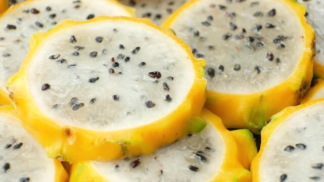 Exotic tropical fruit background with round dragon fruit pitaya slices