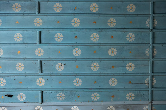 Close-up of a painted wooden ceiling with floral and star motifs, Gers, Saint Georges, France