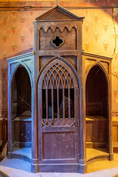 Antique wooden confessional booth with Gothic tracery doors, Gers, Saint Georges, France