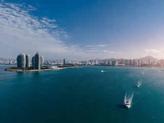 Obraz premium Aerial view of coastal city bay with boats and island towers Sanya Hainan Island, China