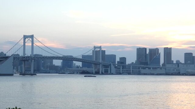 A static long-shot video of the Rainbow Bridge in Minato Ward, Tokyo, at sunset.