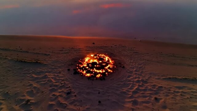 Sunset over tranquil lake with sandy beach and glowing campfire surrounded by tall grass and trees, creating a serene evening atmosphere in nature