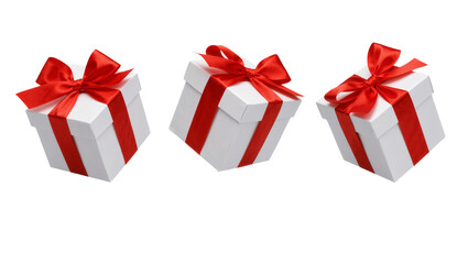 Fototapeta premium Three white gift boxes with red ribbon bows, isolated on transparent background