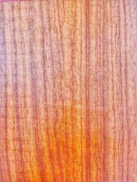 This photo shows a wooden board with a clearly visible natural wood grain texture on its surface. 
