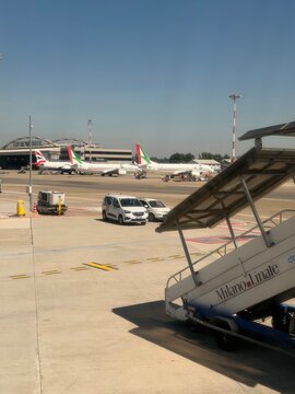 24 April 2026, Italy, Milano Linate LIN airport- Air Dolomiti in apron position with passenger boarding stairs and Aeroitalia planes