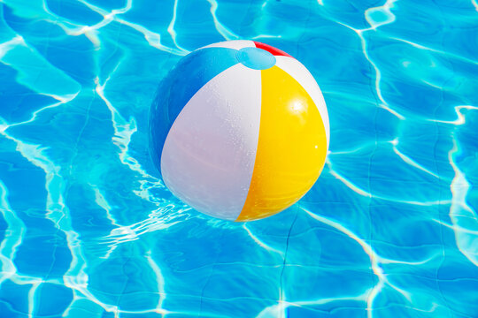 Colorful inflatable ball floating in swimming pool