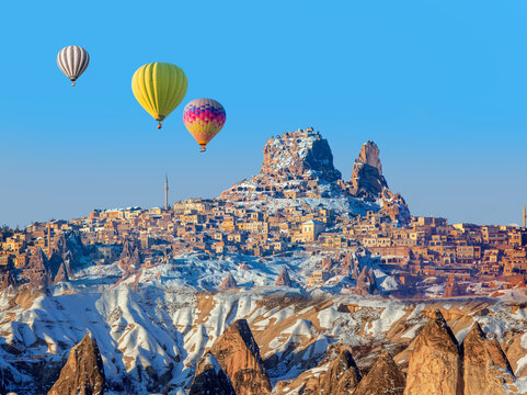 Hot air balloon flying over spectacular Cappadocia at sunset - Goreme, Turkey