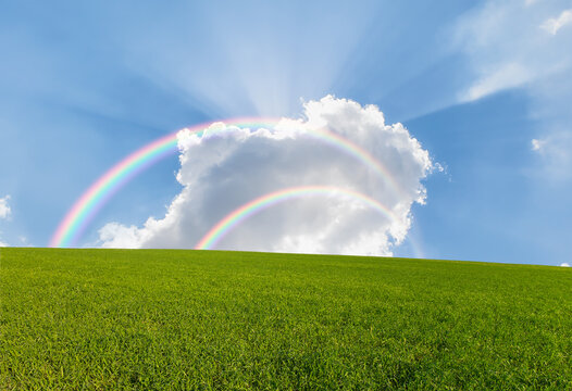 Beautiful landscape with green grass field amazing double rainbow in the background 