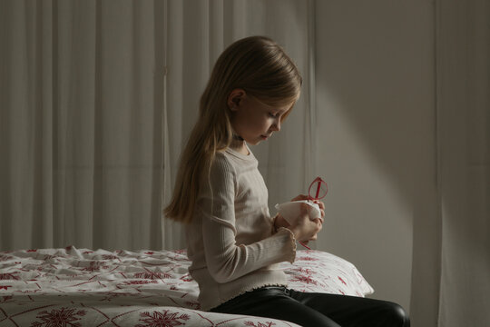 Little Girl Cleaning Her Glasses with Microfiber Cloth Before Bedtime