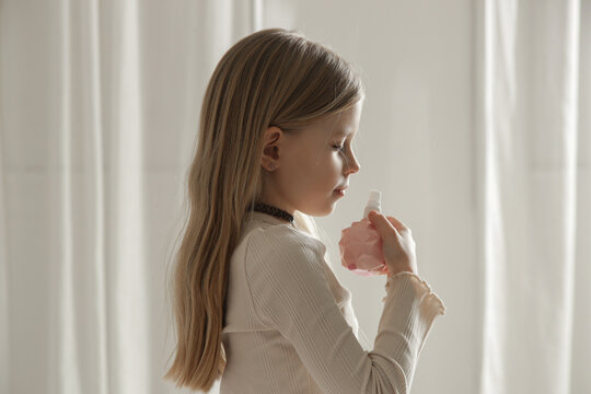Little Girl in Bedroom Applying Kids Perfume &ndash; Childhood Lifestyle and Play Concept
