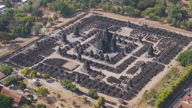 Aerial view of Sewu Temple surrounded by ancient stone stupas and lush trees in Kecamatan Prambanan, Daerah Istimewa Yogya, Indonesia.