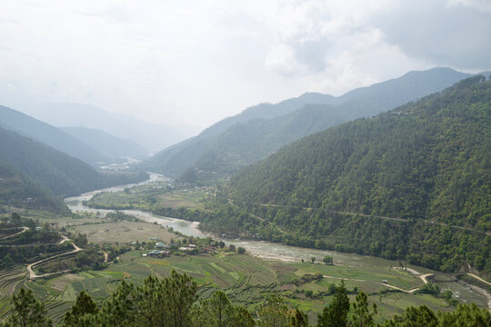 Wide river valley surrounded by misty mountains, Punakha, Punakha, Bhutan