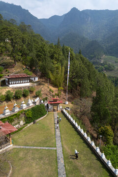 Aerial view of a chorten complex with pilgrims walking below prayer flags, Punakha, Punakha, Bhutan