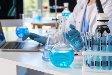 Scientific research and medical innovation, scientist working with laboratory glassware and...