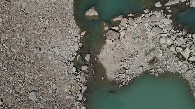 Turquoise Glacial Pool Surrounded by Rugged Alpine Rocks