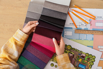 Interior design and home renovation planning, professional designer choosing fabric swatches for...