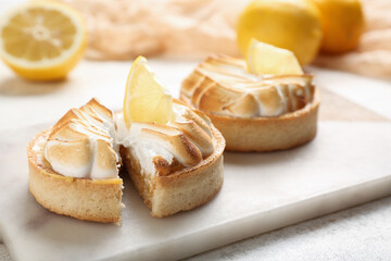 Tasty lemon tartlets on table