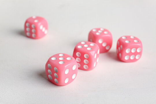 Pink dices on light background