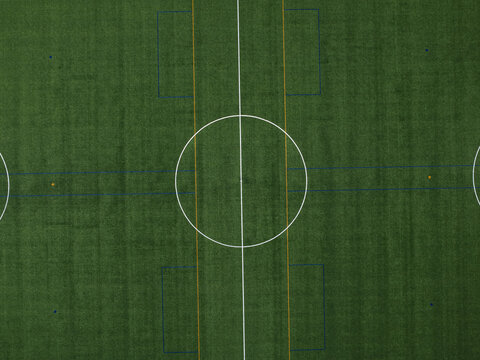 Aerial view of the green artificial turf of the Knox Regional Football Centre with white pitch markings and center circle Wantirna South, Victoria, Australia.