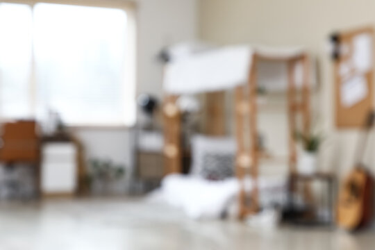 Blurred view of teenagers room with bunk bed and workplace