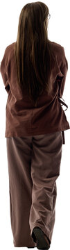 Rear view of young woman in brown loungewear walking on transparent background. Concept of daily routine, home mobility, casual comfort, relaxed living.