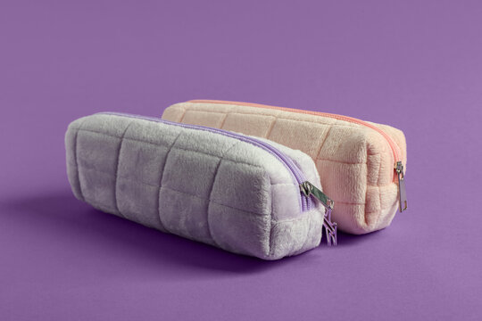 Soft pencil cases on purple background
