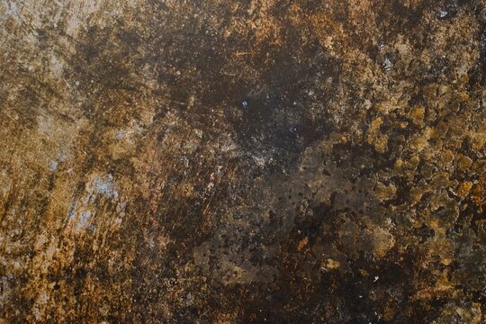 Dark rustic grunge texture featuring weathered concrete, stained rusty metal patina, and aged vintage wall surface ideal for backdrops