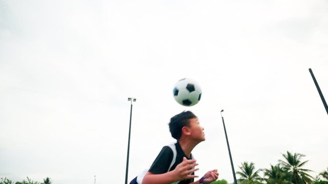 Kid boy leg kicking soccer ball on green grass field action. conceptual metaphor for youth sports training team competition fitness health wellness and active lifestyle	