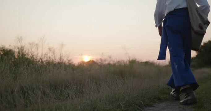 Caucasian man with long hair and Ukrainian traditional folk attire walk wandering near river. 4K 10-bit