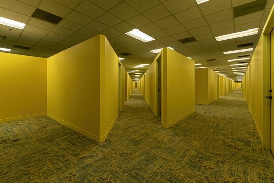 Endless yellow hallways with doors and fluorescent lighting create a disorienting maze