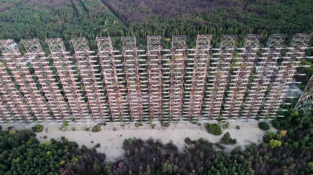 Aerial view of the massive Duga 1 Receiver radar array rising above the surrounding forest in Chernobyl, Kyiv Oblast, Ukraine.