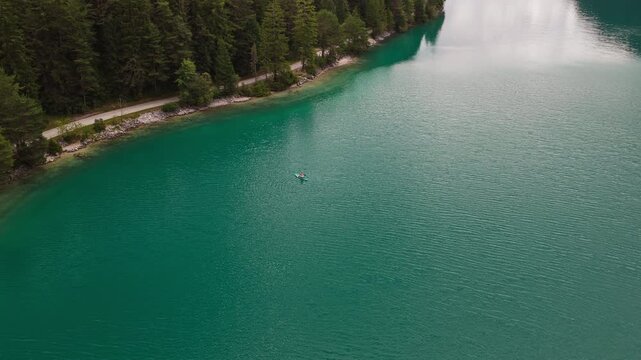Scenic landscape of Lake Achensee in Tyrol, Austria, showing the alpine lake, surrounding mountains and natural shoreline - drone shot